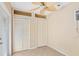 Cozy room featuring two closets, a neutral color palette, tile flooring, and a unique ceiling fan at 335 W Bay St, Winter Garden, FL 34787