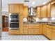 A beautifully designed kitchen featuring stainless steel appliances, granite countertops, and custom wood cabinets at 335 W Bay St, Winter Garden, FL 34787