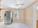 An open kitchen eating area, featuring tile floors, a ceiling fan, and a stainless steel refrigerator at 335 W Bay St, Winter Garden, FL 34787