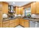 Modern kitchen featuring granite countertops, stainless steel appliances, and custom wood cabinetry at 335 W Bay St, Winter Garden, FL 34787