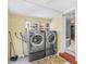 Bright laundry room featuring a modern washer and dryer set with view to outside at 335 W Bay St, Winter Garden, FL 34787
