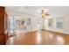 Bright living room with hardwood floors and sunroom through mirrored bi-fold doors at 335 W Bay St, Winter Garden, FL 34787