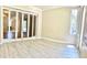 Bright living room with vinyl flooring, folding mirrored doors, and natural light at 335 W Bay St, Winter Garden, FL 34787