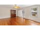 Living room with hardwood floors and ceiling fan, with an enclosed cabinet and a view into the sunroom at 335 W Bay St, Winter Garden, FL 34787