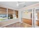 Bright sunroom with hardwood floors, white trim, ceiling fan, and an adjoining room with hardwood floors at 335 W Bay St, Winter Garden, FL 34787