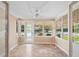 Bright sunroom filled with natural light, featuring tile floors and a ceiling fan at 335 W Bay St, Winter Garden, FL 34787