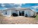 Spacious backyard with a sliding glass door, patio space, and lawn for outdoor enjoyment at 33891 Sky Blossom Cir, Leesburg, FL 34788