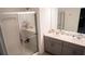A bright bathroom features a double vanity with modern fixtures and an enclosed shower at 33891 Sky Blossom Cir, Leesburg, FL 34788