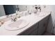 A bathroom with a double vanity features white countertops and cabinets, and modern fixtures at 33891 Sky Blossom Cir, Leesburg, FL 34788