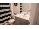 Bathroom with toilet and dark striped shower curtain at 33891 Sky Blossom Cir, Leesburg, FL 34788