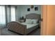 Bedroom with a bed, nightstand, window and curtains at 33891 Sky Blossom Cir, Leesburg, FL 34788