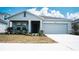 Charming single-story home with a well-manicured lawn and a two-car garage at 33891 Sky Blossom Cir, Leesburg, FL 34788