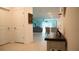 Bright hallway leading to an open floor plan with tile floors and neutral decor at 33891 Sky Blossom Cir, Leesburg, FL 34788