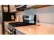 Close-up of a modern kitchen with stainless steel gas range and quartz countertops at 33891 Sky Blossom Cir, Leesburg, FL 34788