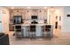 Stylish kitchen featuring a large center island with seating and stainless steel appliances at 33891 Sky Blossom Cir, Leesburg, FL 34788
