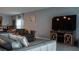 A modern living area features a large television, stylish furniture, and an elegant wall clock at 33891 Sky Blossom Cir, Leesburg, FL 34788