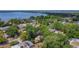 Scenic aerial view of homes near a serene lake, showcasing lush green trees and a peaceful neighborhood setting at 3600 Merryweather Dr, Orlando, FL 32812