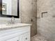 Modern bathroom featuring a walk-in shower with sleek tile, granite countertops, and contemporary fixtures at 3600 Merryweather Dr, Orlando, FL 32812