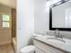 Bright bathroom featuring granite countertop, white vanity, and tiled shower/tub combo at 3600 Merryweather Dr, Orlando, FL 32812
