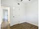 Clean bedroom with wood-look flooring, a ceiling fan, and a bright white door leading to the rest of the home at 3600 Merryweather Dr, Orlando, FL 32812