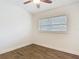 Bedroom featuring wood-look tile flooring, white walls, and a window for natural light at 3600 Merryweather Dr, Orlando, FL 32812