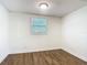 Bedroom with hardwood floors, neutral paint, and ample natural light from a window at 3600 Merryweather Dr, Orlando, FL 32812