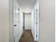 Hallway with wood-look tile flooring, white doors, and recessed lighting at 3600 Merryweather Dr, Orlando, FL 32812