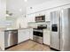 Well-equipped kitchen with stainless steel appliances, white cabinetry, granite countertops and tile flooring at 3600 Merryweather Dr, Orlando, FL 32812