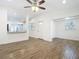 Bright and open living room layout with views into the kitchen, hardwood floors, and neutral colors at 3600 Merryweather Dr, Orlando, FL 32812