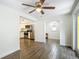 Open concept living room with wood-look tile flooring leading to a kitchen with stainless steel appliances at 3600 Merryweather Dr, Orlando, FL 32812