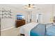 Comfortable bedroom featuring a ceiling fan, shelving, and a view into the ensuite bathroom at 3632 Gretchen Dr, Ocoee, FL 34761