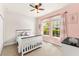 Bright bedroom features a ceiling fan and large windows allowing for lots of natural light at 3632 Gretchen Dr, Ocoee, FL 34761