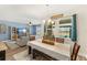 Charming dining area with plenty of natural light, complemented by a stylish light fixture and view of the pool at 3632 Gretchen Dr, Ocoee, FL 34761