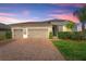 Charming single-story home with a three-car garage, brick paver driveway, and well-maintained landscaping at 3632 Gretchen Dr, Ocoee, FL 34761