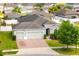 Beautiful single story home showcasing a three car garage and a manicured lawn at 3632 Gretchen Dr, Ocoee, FL 34761