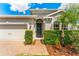 Welcoming front entryway with a decorative wreath and manicured landscaping at 3632 Gretchen Dr, Ocoee, FL 34761