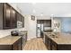 Modern kitchen featuring stainless steel appliances, granite countertops, and ample cabinet space at 3632 Gretchen Dr, Ocoee, FL 34761