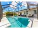 A sparkling pool is surrounded by sun loungers and patio furniture in a screened enclosure at 3632 Gretchen Dr, Ocoee, FL 34761