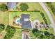 Aerial view of a home with a lush green lawn, circular driveway, pool, and landscaping at 3640 Crump Rd, Winter Haven, FL 33881