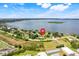Aerial view of a house on a landscaped lot by a lake at 3640 Crump Rd, Winter Haven, FL 33881