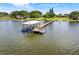 Scenic aerial view of a private boat dock on the water, complete with a covered slip at 3640 Crump Rd, Winter Haven, FL 33881