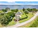 Aerial view of an estate home with meticulous landscaping and lake views at 3640 Crump Rd, Winter Haven, FL 33881