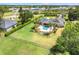 Aerial view of a home's backyard oasis with a sparkling pool, lush greenery, and patio furniture at 3640 Crump Rd, Winter Haven, FL 33881