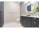 A modern half bathroom has an artistic sink, mosaic tile accent wall, and storage at 3640 Crump Rd, Winter Haven, FL 33881