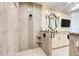This walk-in shower is adorned with luxurious marble tile and a glass door at 3640 Crump Rd, Winter Haven, FL 33881