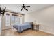 Bedroom featuring a bed, side table, wood-look floors and a window with blinds at 3640 Crump Rd, Winter Haven, FL 33881