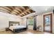 A cozy main bedroom features a tray ceiling with a beautiful waterfront view at 3640 Crump Rd, Winter Haven, FL 33881