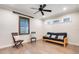 Bedroom featuring a futon, two wood chairs, wood-look flooring, and a window at 3640 Crump Rd, Winter Haven, FL 33881