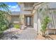 Elegant entryway with a decorative glass front door, stone accents, and manicured landscaping at 3640 Crump Rd, Winter Haven, FL 33881
