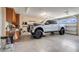 An oversized truck parked inside a clean and organized garage with custom cabinets at 3640 Crump Rd, Winter Haven, FL 33881